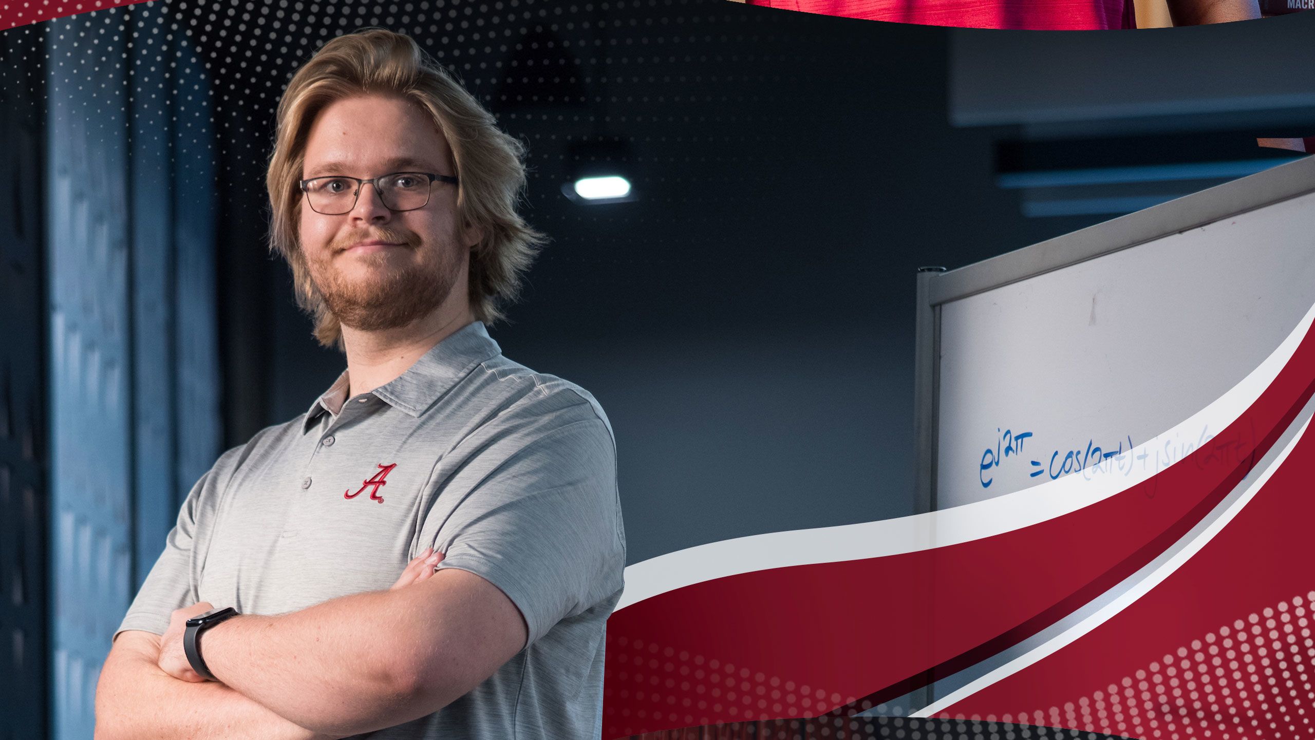 Brodie Alexander posing near a whiteboard in a lab.
